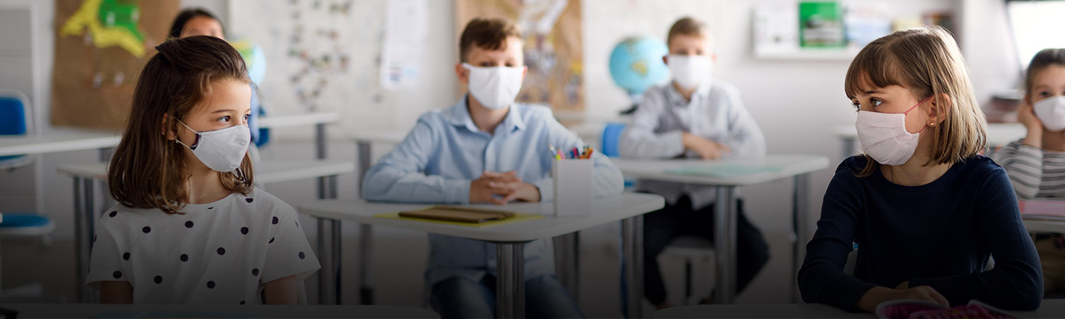 Children with face mask back at school after covid-19 quarantine and lockdown